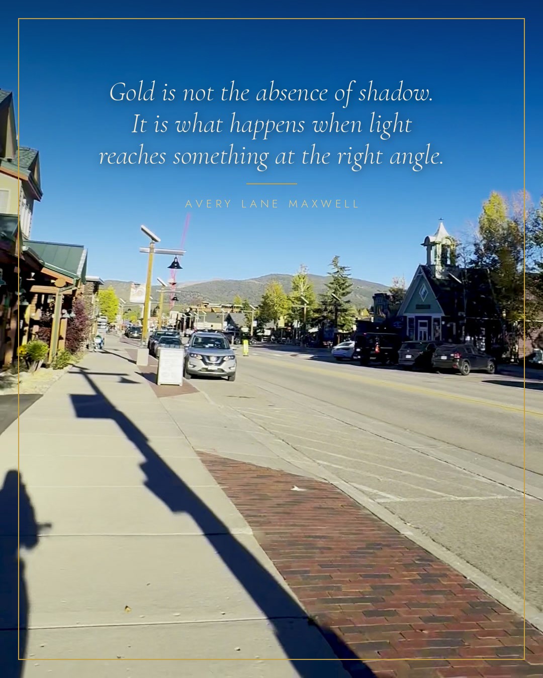 Main Street in Frisco at the gold hour, a long shadow across the brick, the line set in the sky above it.
