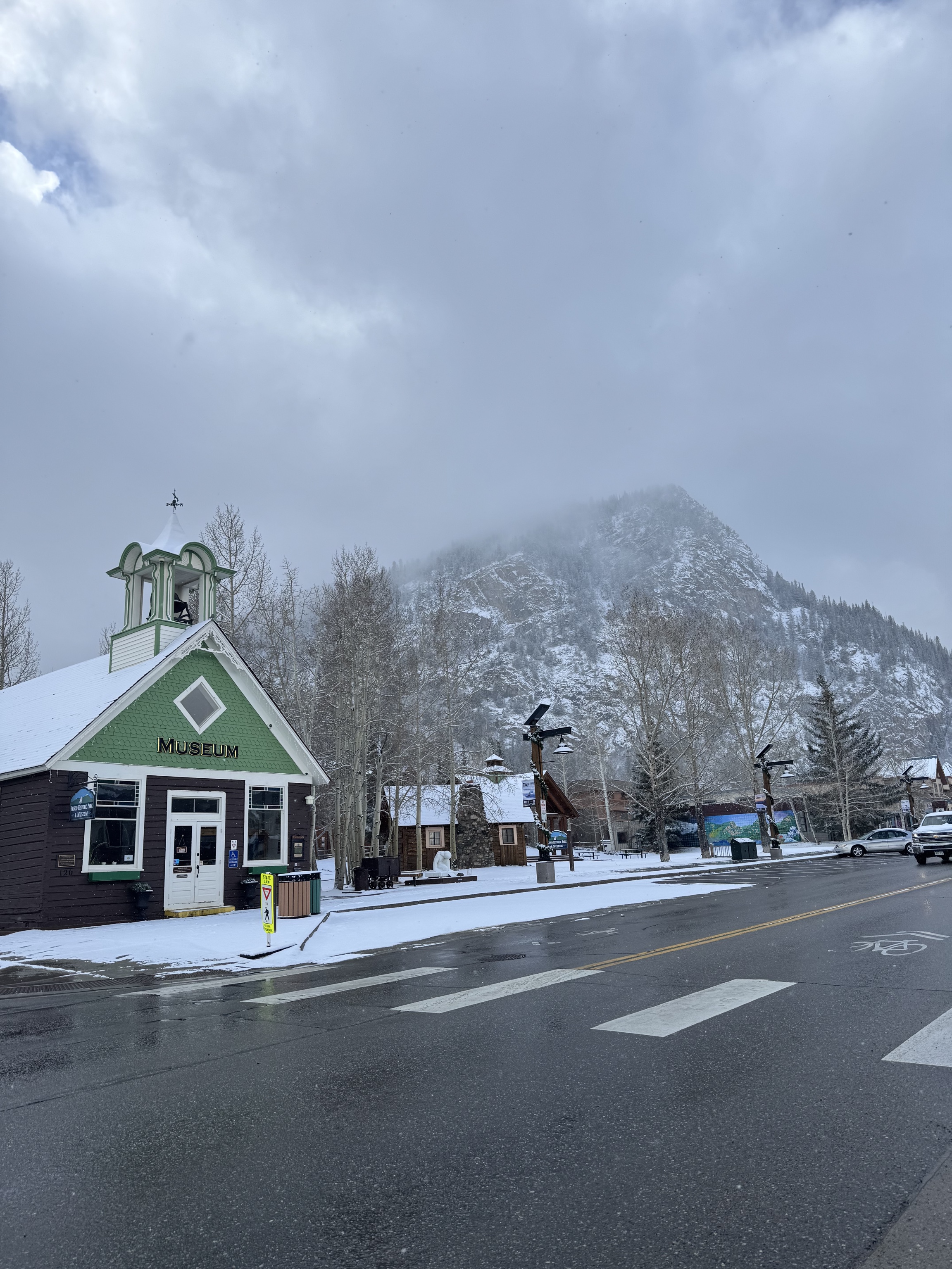 A snowy morning on Main Street in Frisco, Colorado, the mountain in cloud behind it.