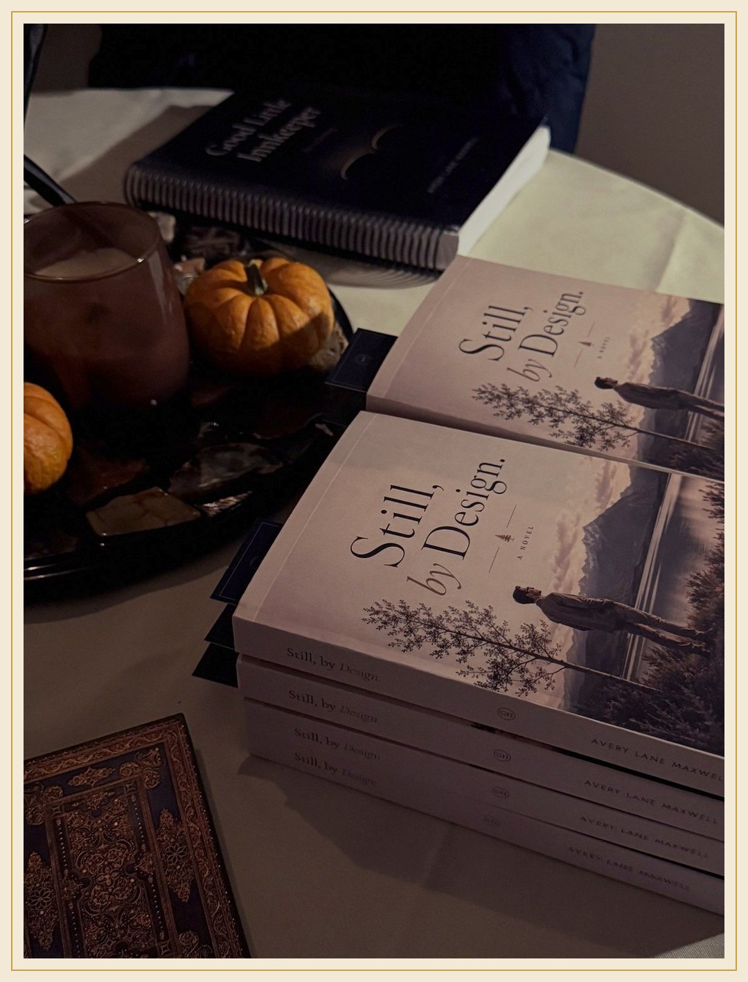 Small pumpkins on a table beside copies of the book.