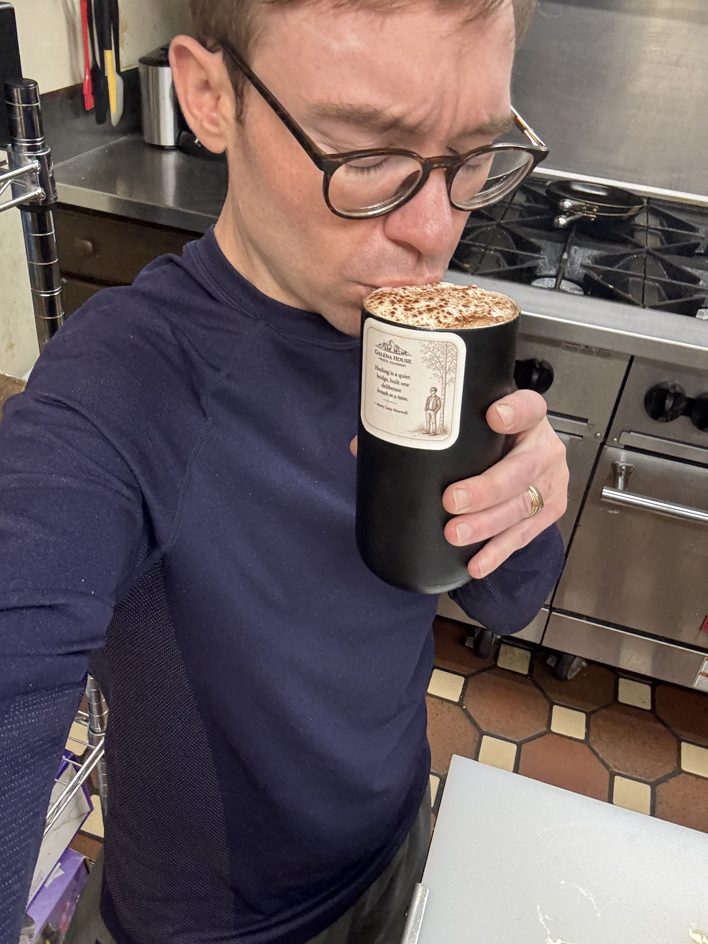 A latte at the front desk, early, before anyone is awake.