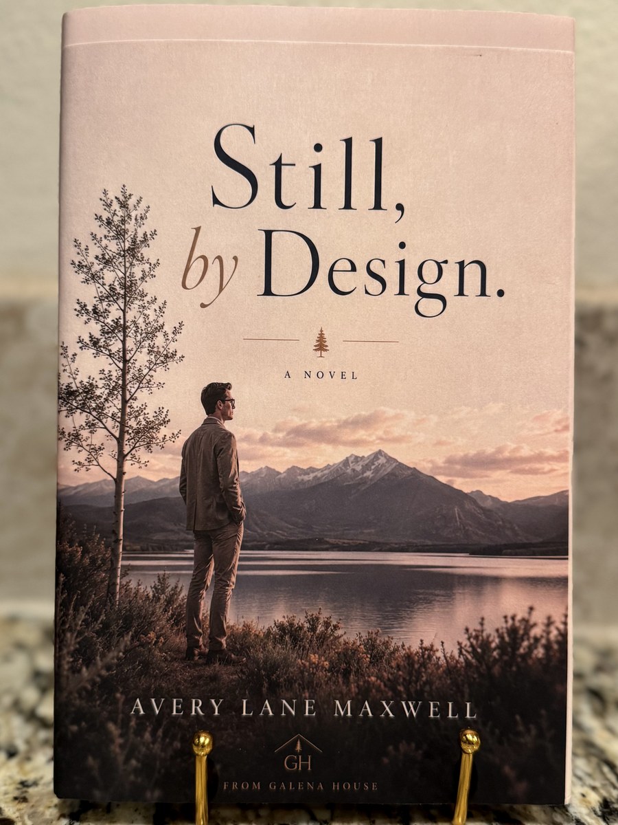 Still, by Design. · the jacketed hardcover, standing on the desk